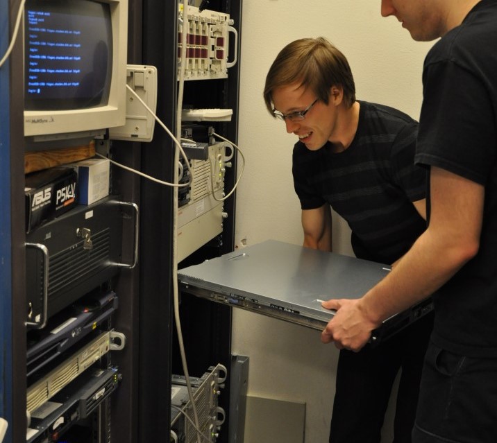 Engineers installing a rack mountable server
